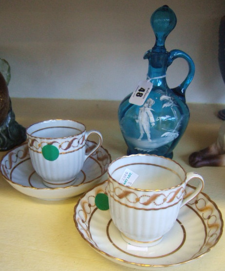 Appraisal: A pair of porcelain gilt decorated teacups and saucers early