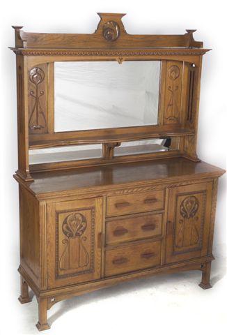 Appraisal: ART NOUVEAU OAK MIRROR-BACKED SIDEBOARD c the shelved superstructure with