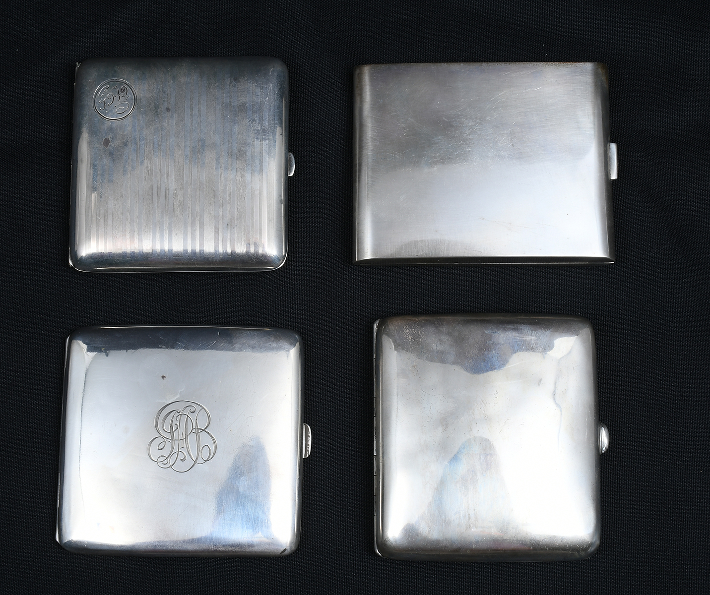 Appraisal: ART DECO STERLING CIGARETTE CASES Comprising Curved case by an