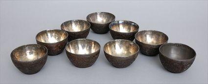 Appraisal: SET OF TEN CHINESE SILVER-LINED CARVED COCONUT SHELL BOWLS The