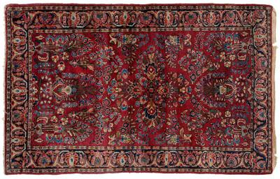 Appraisal: Sarouk rug typical floral designs on burgundy red field s