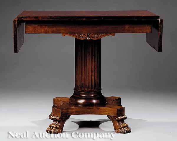 Appraisal: A Regency-Style Mahogany Drop-Leaf Sofa Table c with foliate scrolled