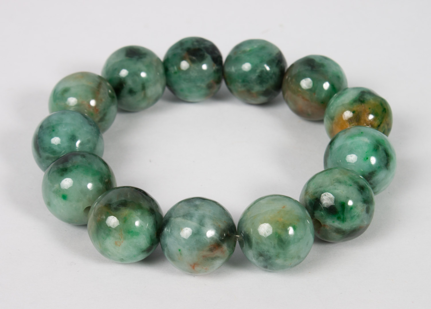 Appraisal: Mottled green and white jade bead bracelet