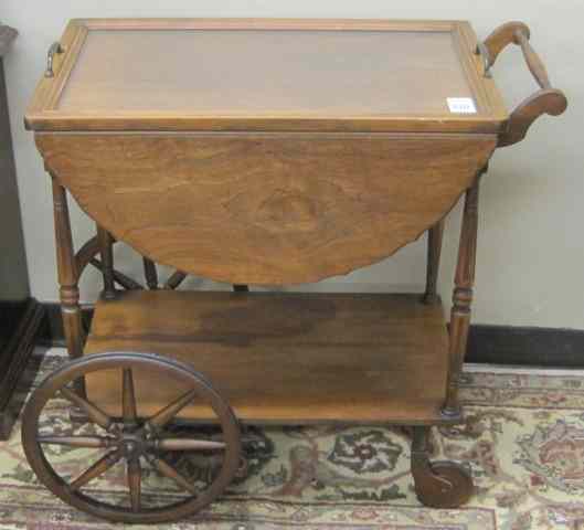 Appraisal: WALNUT DROP-LEAF TEACART American c 's a rectangular -tier cart