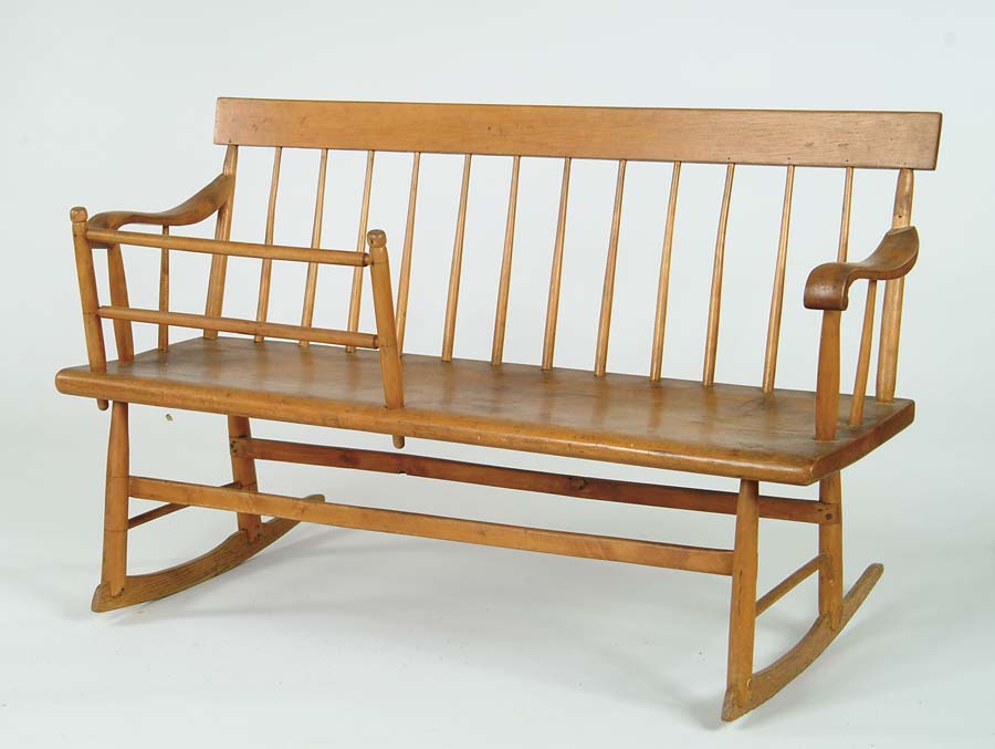 Appraisal: WINDSOR MAMMIES ROCKING BENCH Plank seat supports a twelve spindled