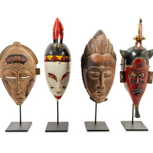 Appraisal: Four African Masks th Century with stands for each Height