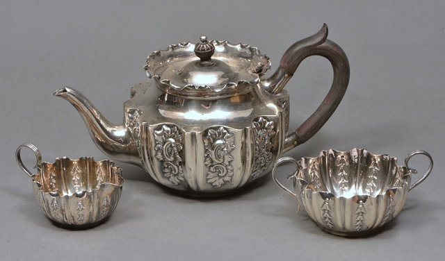 Appraisal: A LATE VICTORIAN SILVER TEAPOT with fluted sides chased with