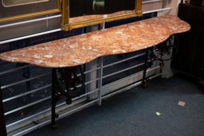 Appraisal: A console table with marble top having iron end supports