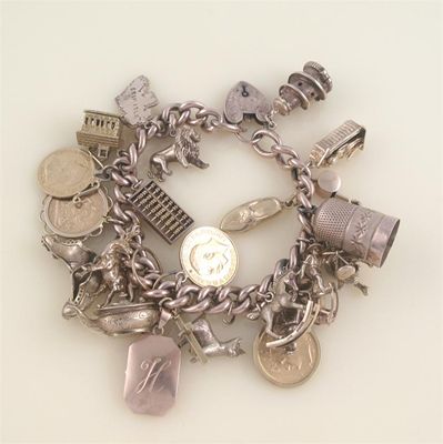 Appraisal: A gold charm bracelet the ct gold curb link bracelet