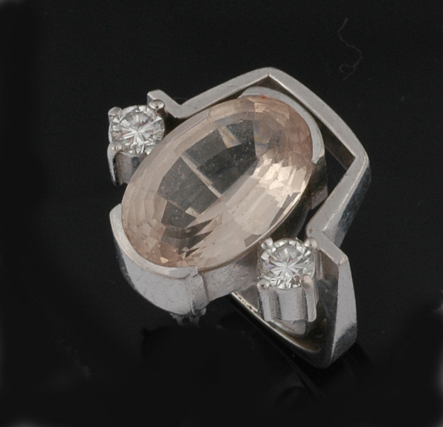 Appraisal: A TOPAZ AND DIAMOND RING The oval fancy cut champagne