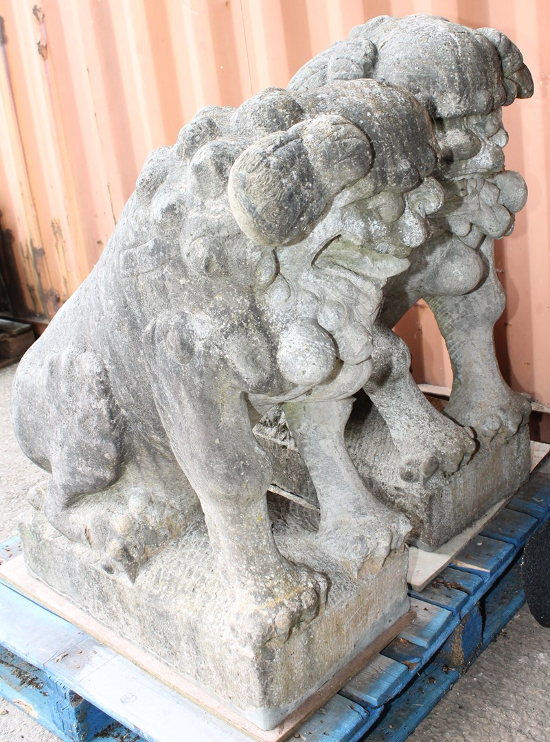 Appraisal: A large pair of carved granite seated temple dogs on