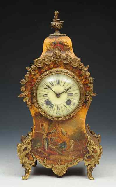 Appraisal: A LOUIS XV STYLE MANTEL CLOCK the lobed cream enamel