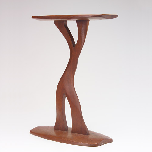 Appraisal: ROBERT WHITLEY Carved walnut accent table with free-form top and