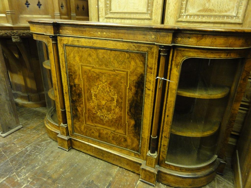 Appraisal: A Victorian walnut credenza with decorative well matched figured and