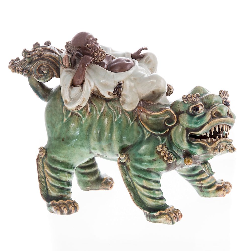 Appraisal: Chinese Porcelain Figure of Sage Riding Foo Dog late th