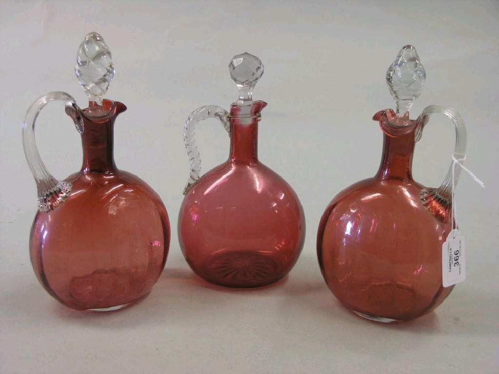 Appraisal: A pair of Victorian cranberry glass ewers bulbous-shape each with