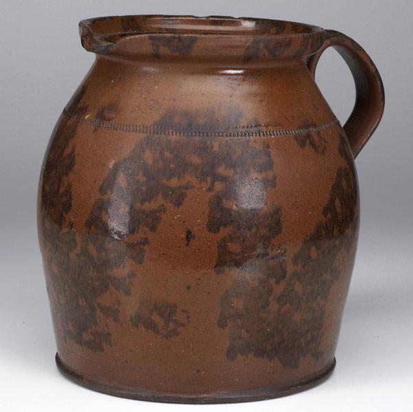 Appraisal: Manganese-decorated redware pitcher th C Coggle wheel decoration with minor