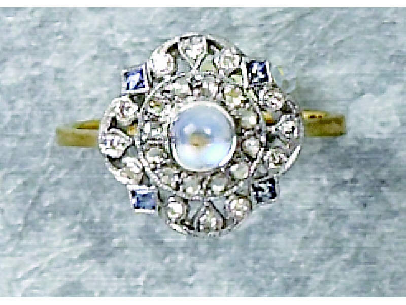 Appraisal: MOONSTONE AND DIAMOND RING k yellow gold ring with white