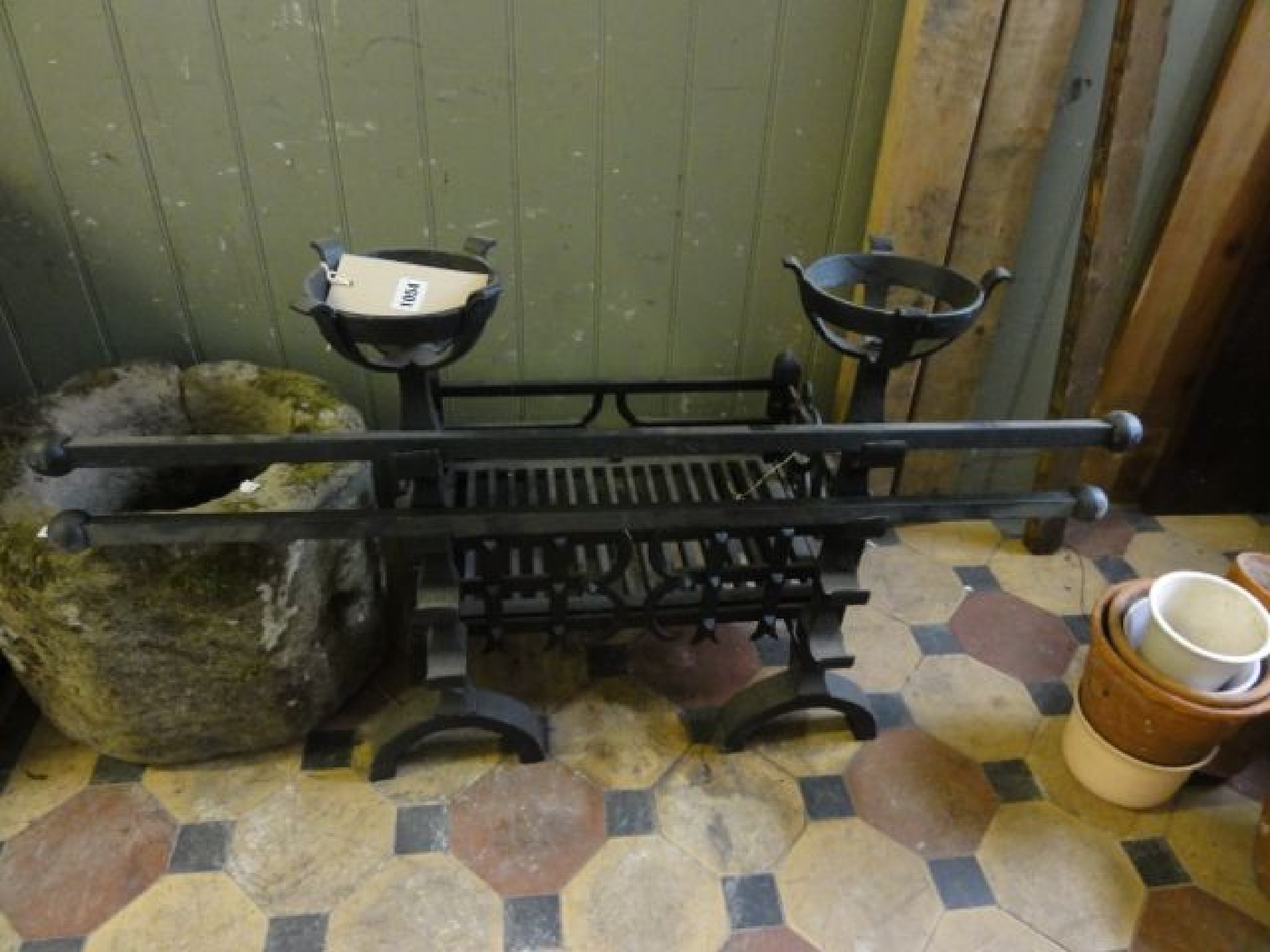 Appraisal: An old English style cast iron fire basket with trellis