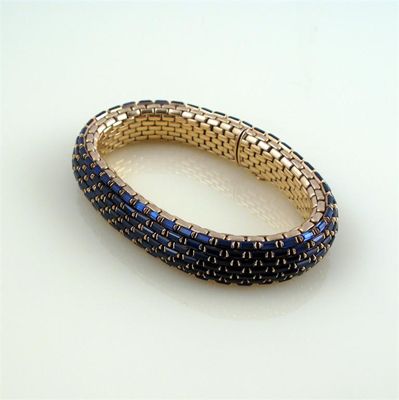 Appraisal: A synthetic sapphire and gold bracelet the articulated and flexible