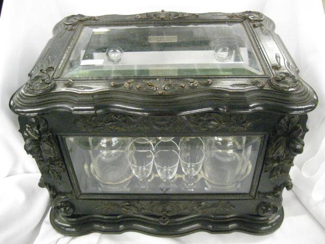 Appraisal: Black Forest Carved Wooden Liquor Cabinet bevelled glass hinged top