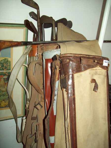 Appraisal: A COLLECTION OF ANTIQUE GOLF CLUBS AND CANVAS BAGS