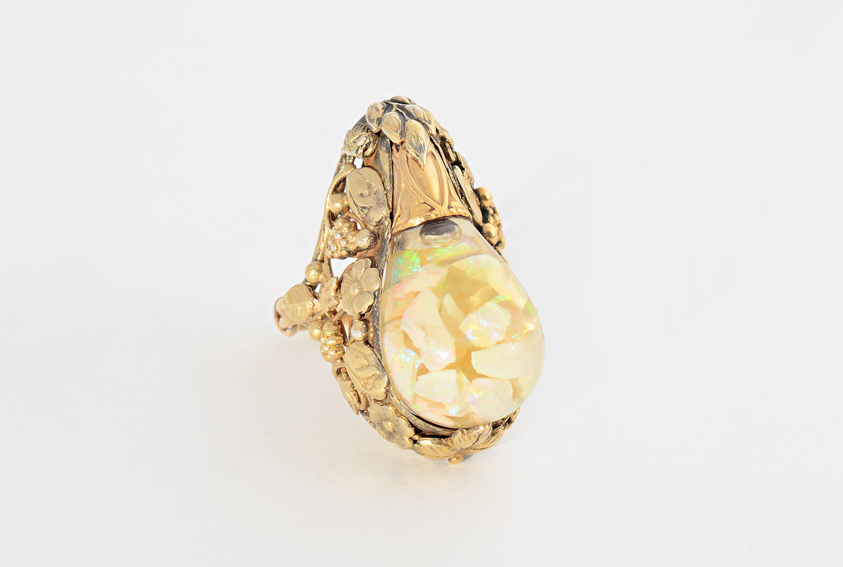 Appraisal: FLOATING OPAL RING K yellow gold ring featuring a glass