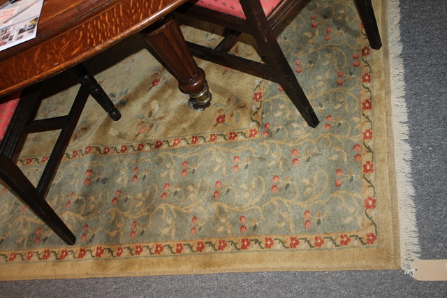 Appraisal: A CFA VOYSEY STYLE RUST GROUND RUG with wide blue