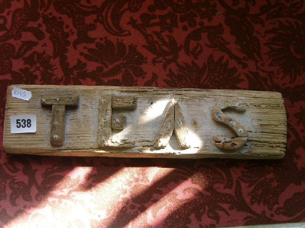 Appraisal: A weathered wooden sign advertising Teas