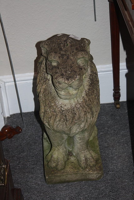 Appraisal: A PAIR OF RECONSTITUTED STONE STANDING LIONS each on a