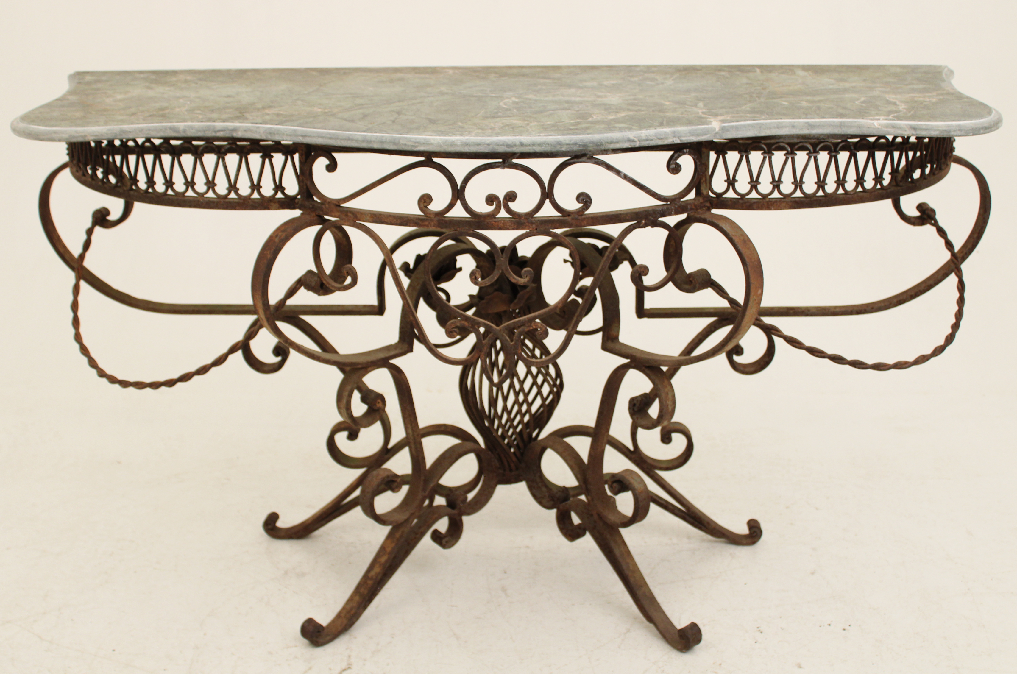 Appraisal: SERPENTINE FORMED IRON MARBLE TOP CONSOLE Decorative Transitional style wrought