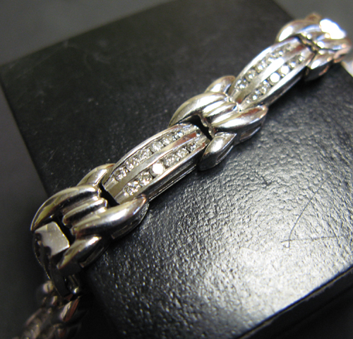 Appraisal: DIAMOND AND FOURTEEN KARAT WHITE GOLD BRACELET set with round-cut