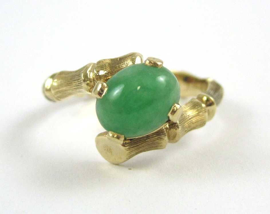 Appraisal: GREEN JADE AND FOURTEEN KARAT GOLD RING The yellow gold