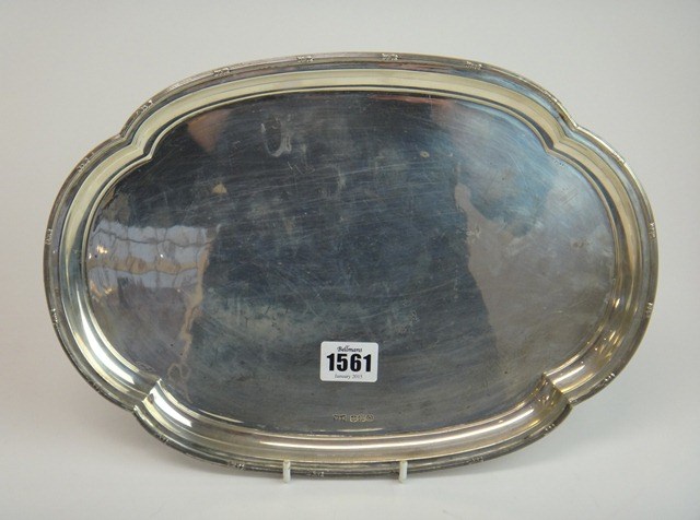 Appraisal: A silver shaped oval dressing table tray with a decorated