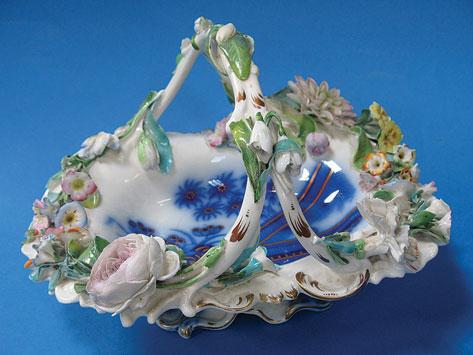 Appraisal: A VICTORIAN STAFFORDSHIRE BASKET of rococo design with overhead branch