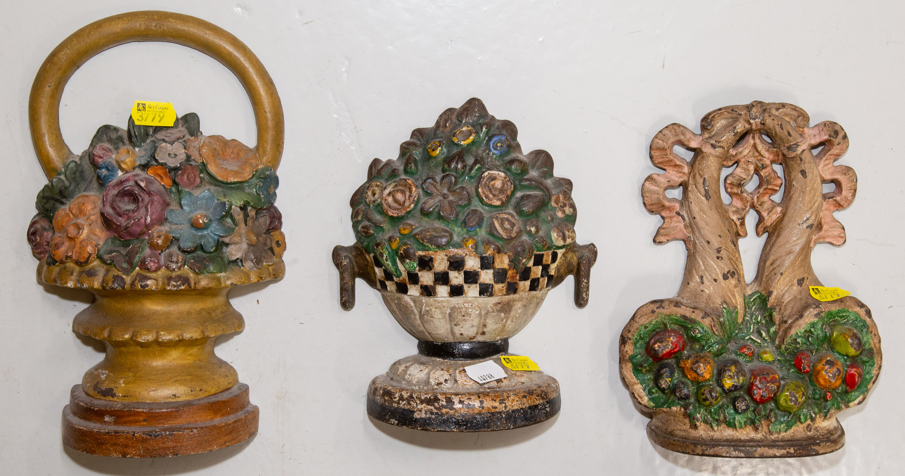 Appraisal: THREE PAINTED CAST IRON DOOR STOPS Early th century including