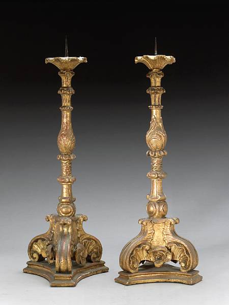 Appraisal: A pair of Italian giltwood candle prickets th century The