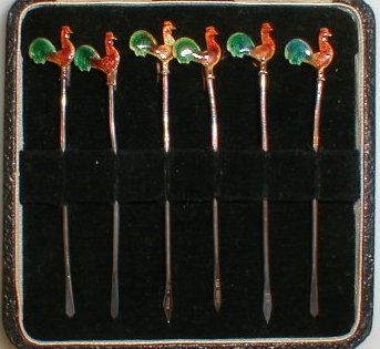 Appraisal: A cased set of six silver cocktail sticks topped by