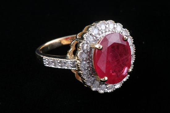 Appraisal: K YELLOW GOLD RUBY AND DIAMOND RING Prong-set oval ruby