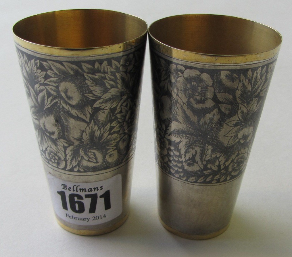 Appraisal: A pair of Russian niello decorated small beakers decorated with