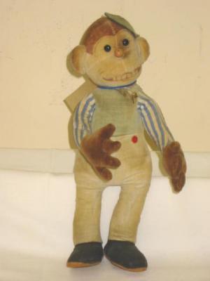 Appraisal: A soft monkey doll covered in velvet with button eyes