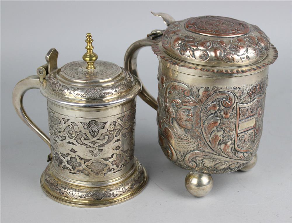 Appraisal: TWO SILVERPLATED BEER STEINS th Century the first silver over