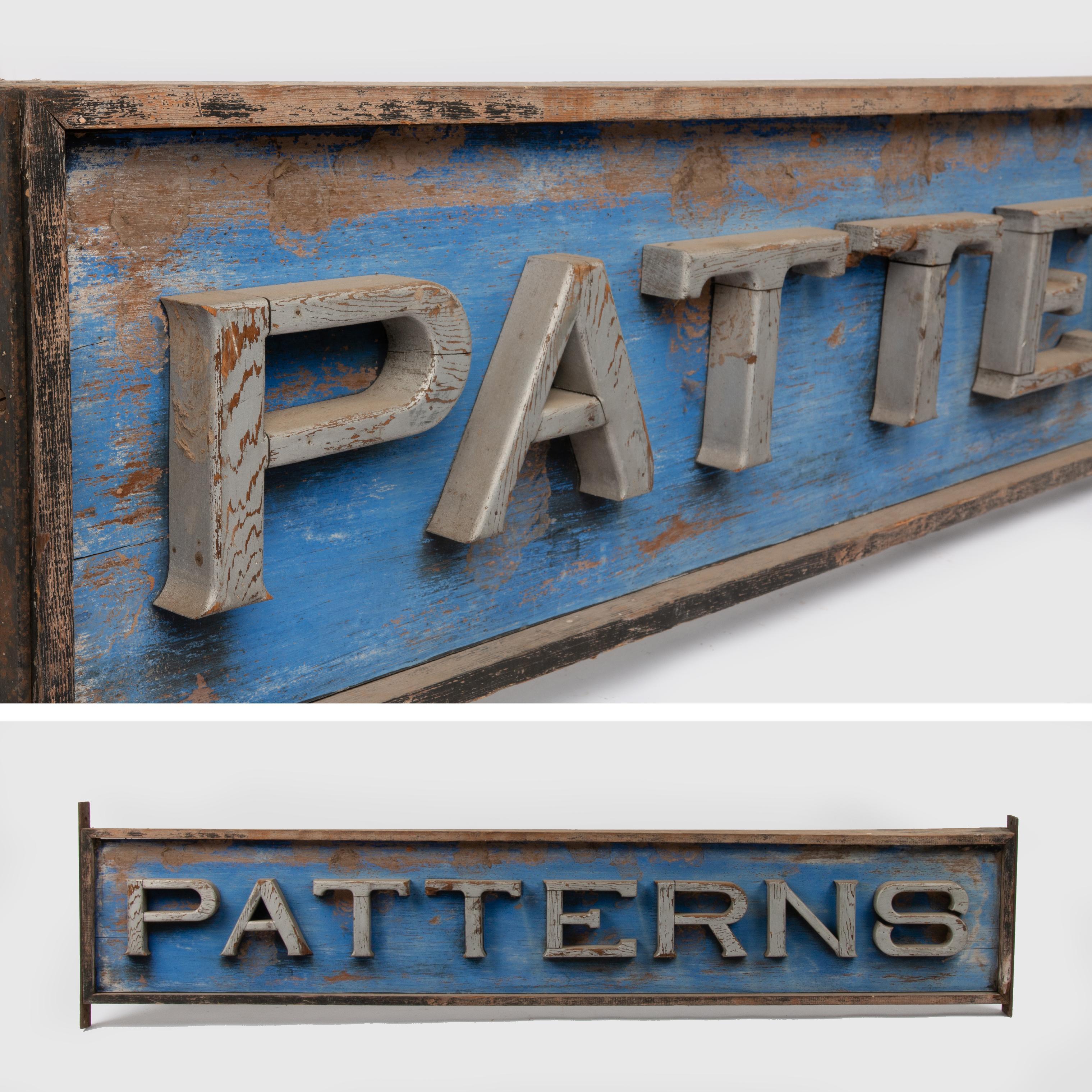 Appraisal: ANTIQUE WOODEN PATTERNS DOUBLE-SIDED SIGN A large blue-painted wooden double-sided