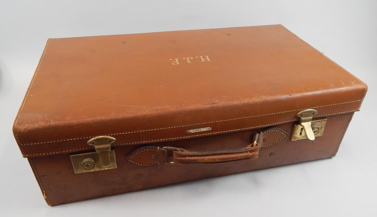 Appraisal: A leather suitcase bearing the initials H J F