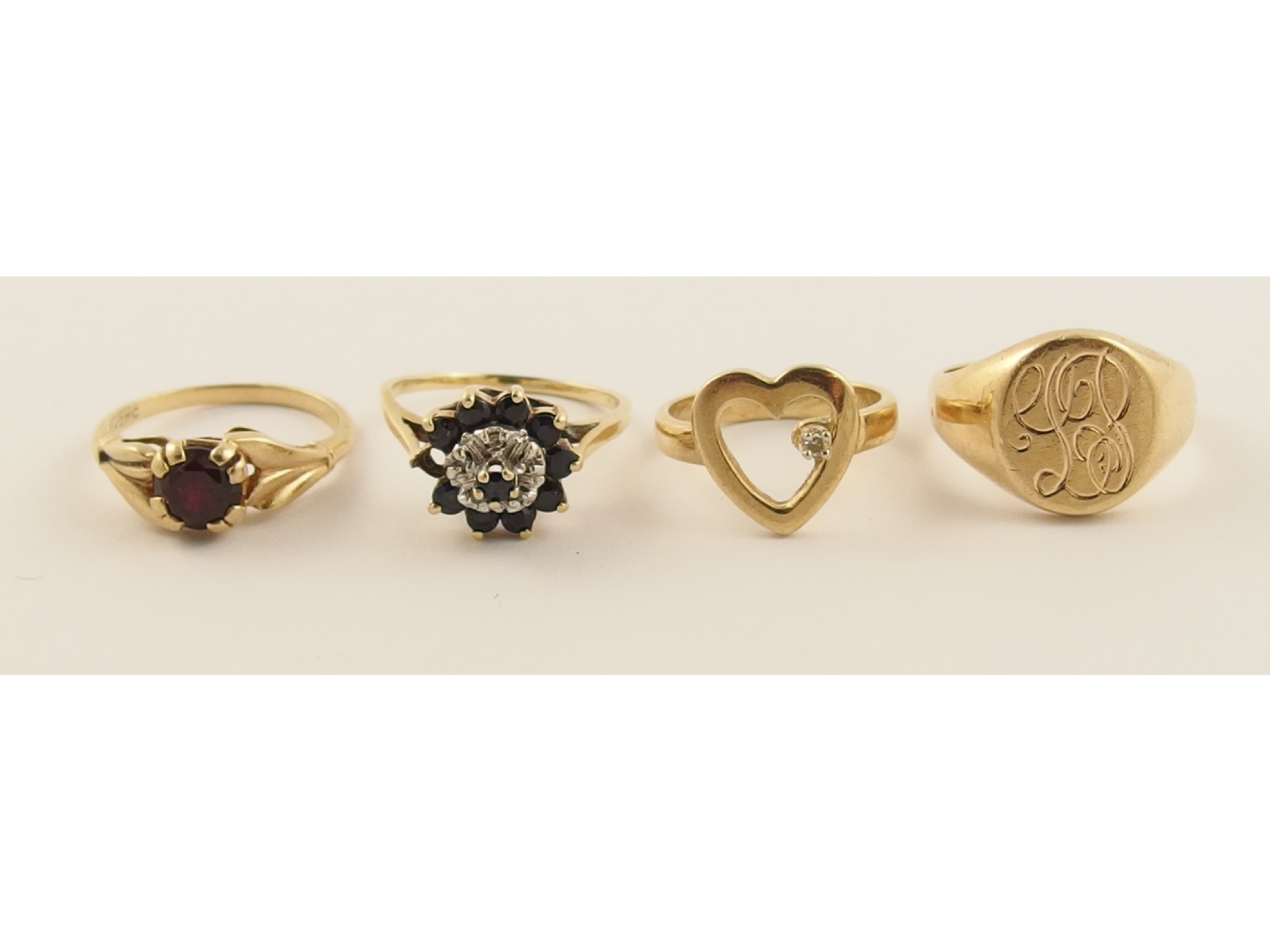 Appraisal: Three k rings and a yellow metal heart shaped ring