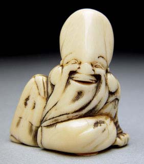 Appraisal: ANTIQUE IVORY NETSUKE Antique ivory netsuke carved from a triangular