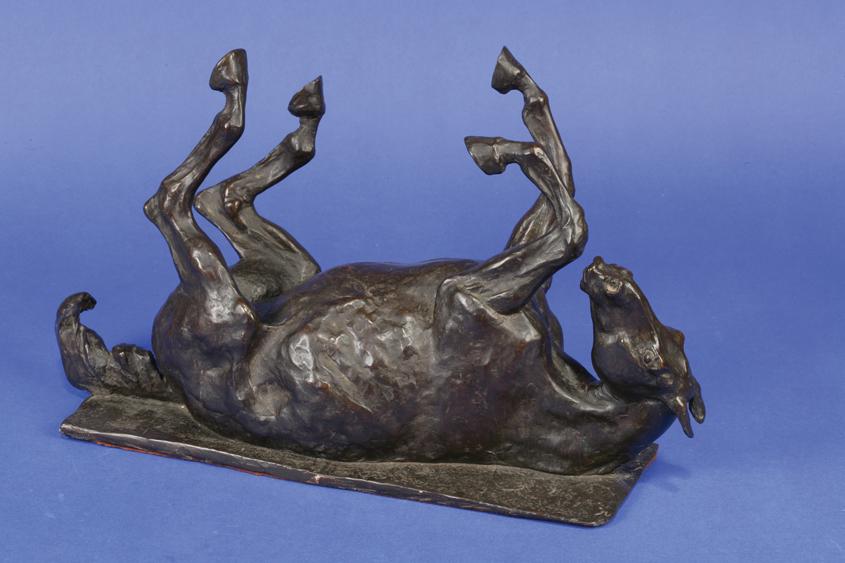 Appraisal: ENGLISH SCHOOL A cast bronze of a rolling horse with