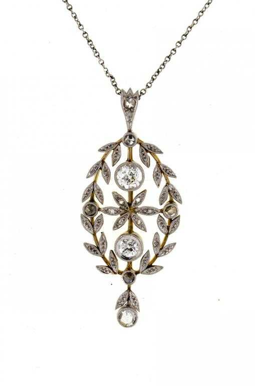 Appraisal: A DIAMOND PENDANT with two diamond collets framed by husks