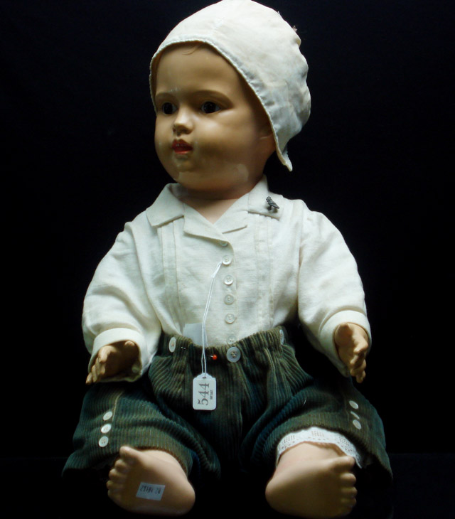 Appraisal: A German celluloid baby doll with moulded hair and painted