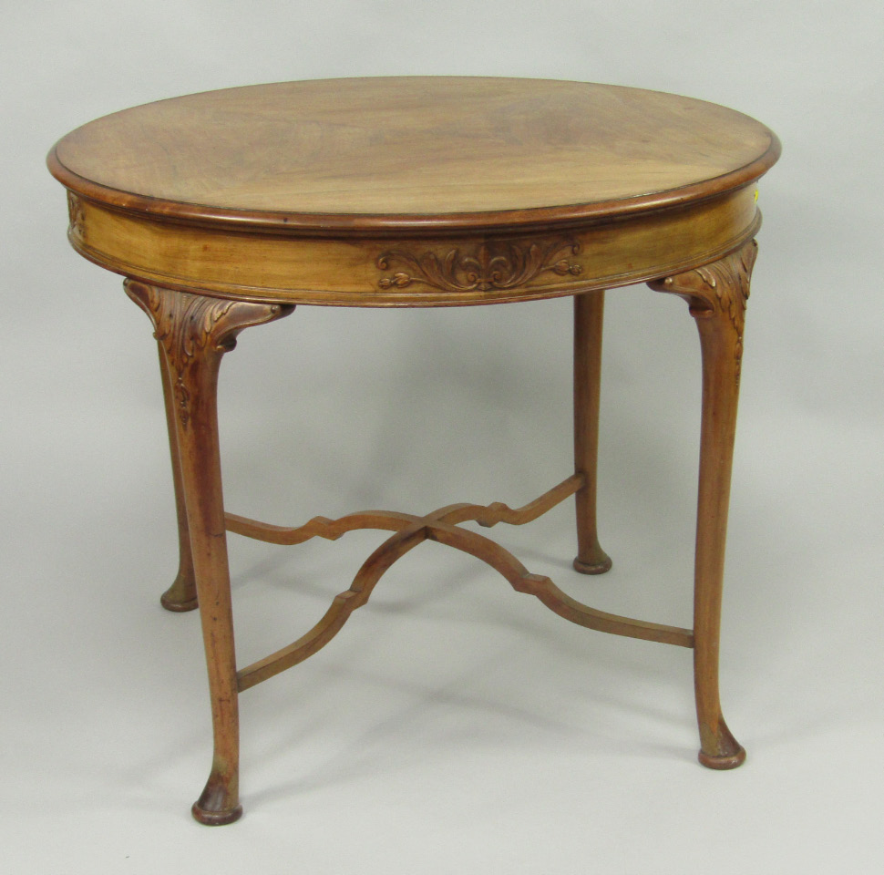 Appraisal: A early thC walnut circular centre table the side carved